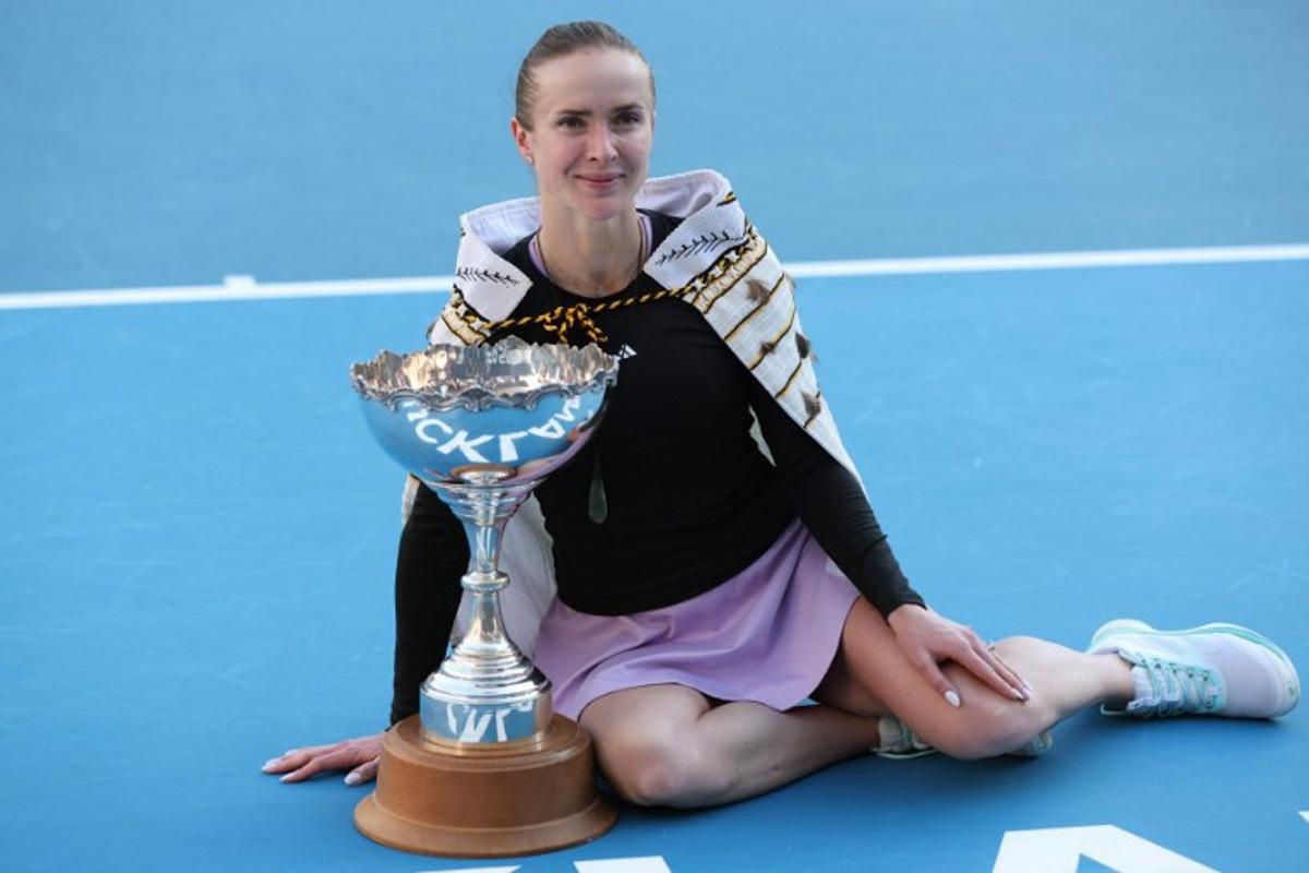 Ukraine's Elina Svitolina celebrates with the trophy after her win against China's Wang Xinyu during the women's singles final at the WTA Auckland Classic tennis tournament in Auckland on January 11, 2026.  Michael Bradley / AFP