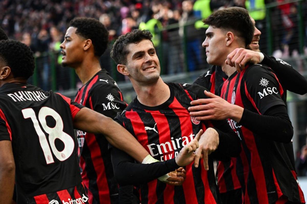 AC Milan's US forward #11 Christian Pulisic (C) celebrates after scoring his team's first goal during the Italian Serie A football match between AC Milan and Hellas Verona at the San Siro stadium in Milan, northern Italy, on December 28, 2025.  Piero CRUCIATTI / AFP