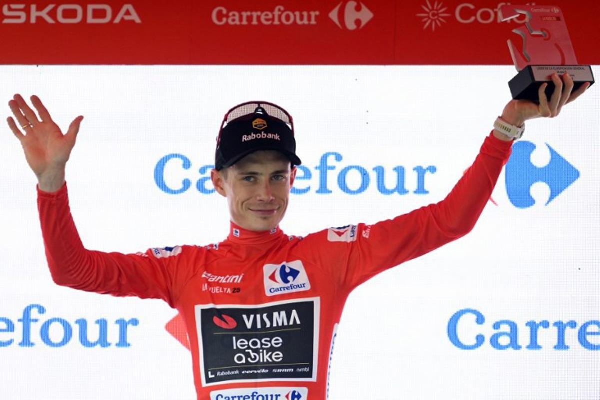 Team Visma-Lease a bike's Danish rider Jonas Vingegaard celebrates on the podium wearing the overall leader red jersey after the fifth stage of La Vuelta a Espana cycling tour, a 24.1 km time-trial team race in Figueres, on August 27, 2025.    Josep LAGO / AFP