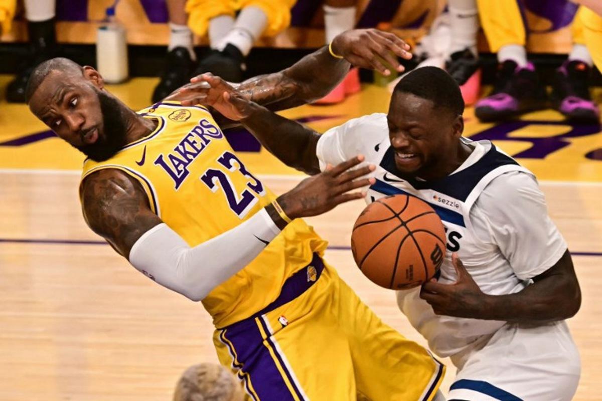Los Angeles Lakers' US small forward #23 LeBron James (L) is fouled by Minnesota Timberwolves' US power forward #30 Julius Randle during the NBA game season opener between the Los Angeles Lakers and the Minnesota Timberwolves at Crypto Arena in Los Angeles on October 22, 2024.  Frederic J. Brown / AFP