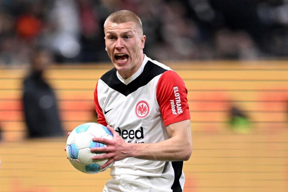 Frankfurt's Danish defender #13 Rasmus Kristensen holds the ball as he reacts during the German first division Bundesliga football match between Eintracht Frankfurt and VfB Stuttgart in Frankfurt on March 29, 2025. Kirill KUDRYAVTSEV / AFP