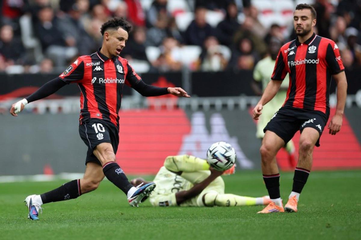 Monaco's Senegalese midfielder #15 Lamine Camara (C) fights for the ball with Nice's Moroccan forward #10 Sofiane Diop (L) during the French L1 football match between OGC Nice and AS Monaco at the Allianz Riviera Stadium in Nice, south-eastern France, on February 8, 2026. Valery HACHE / AFP