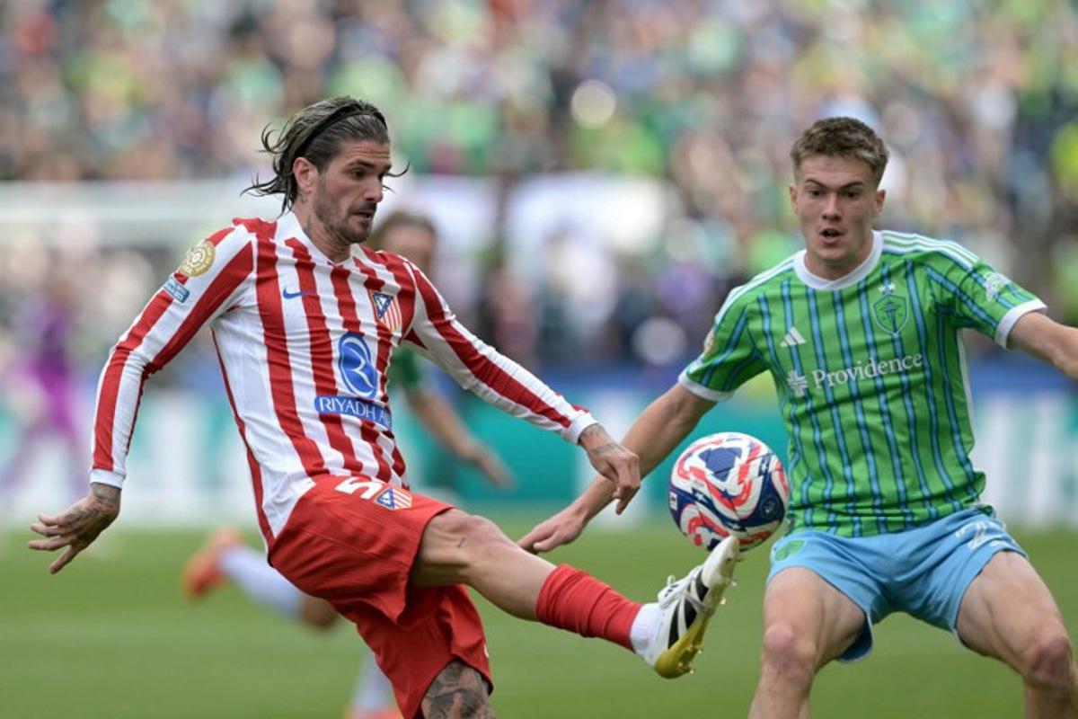 Atletico Madrid's Argentine midfielder #05 Rodrigo De Paul and Seattle Sounders' US midfielder #21 Reed Baker-Whiting fight for the ball during the FIFA Club World Cup 2025 Group B football match between US Seattle Sounders and Spain's Atletico de Madrid at the Lumen Field stadium in Seattle on June 19, 2025. JUAN MABROMATA / AFP