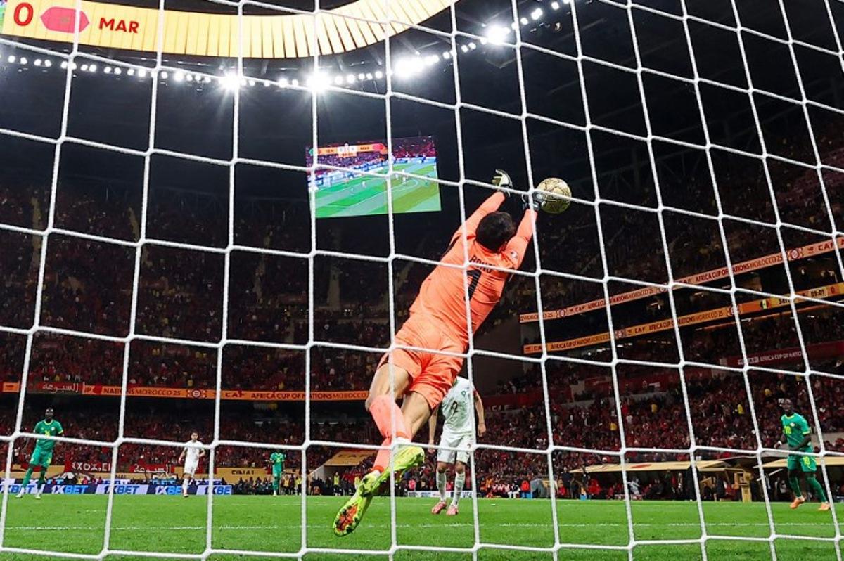 Morocco's goalkeeper #01 Yassine Bounou foils an attempt during the Africa Cup of Nations (CAN) final football match between Senegal and Morocco at the Prince Moulay Abdellah Stadium in Rabat on January 18, 2026. FRANCK FIFE / AFP