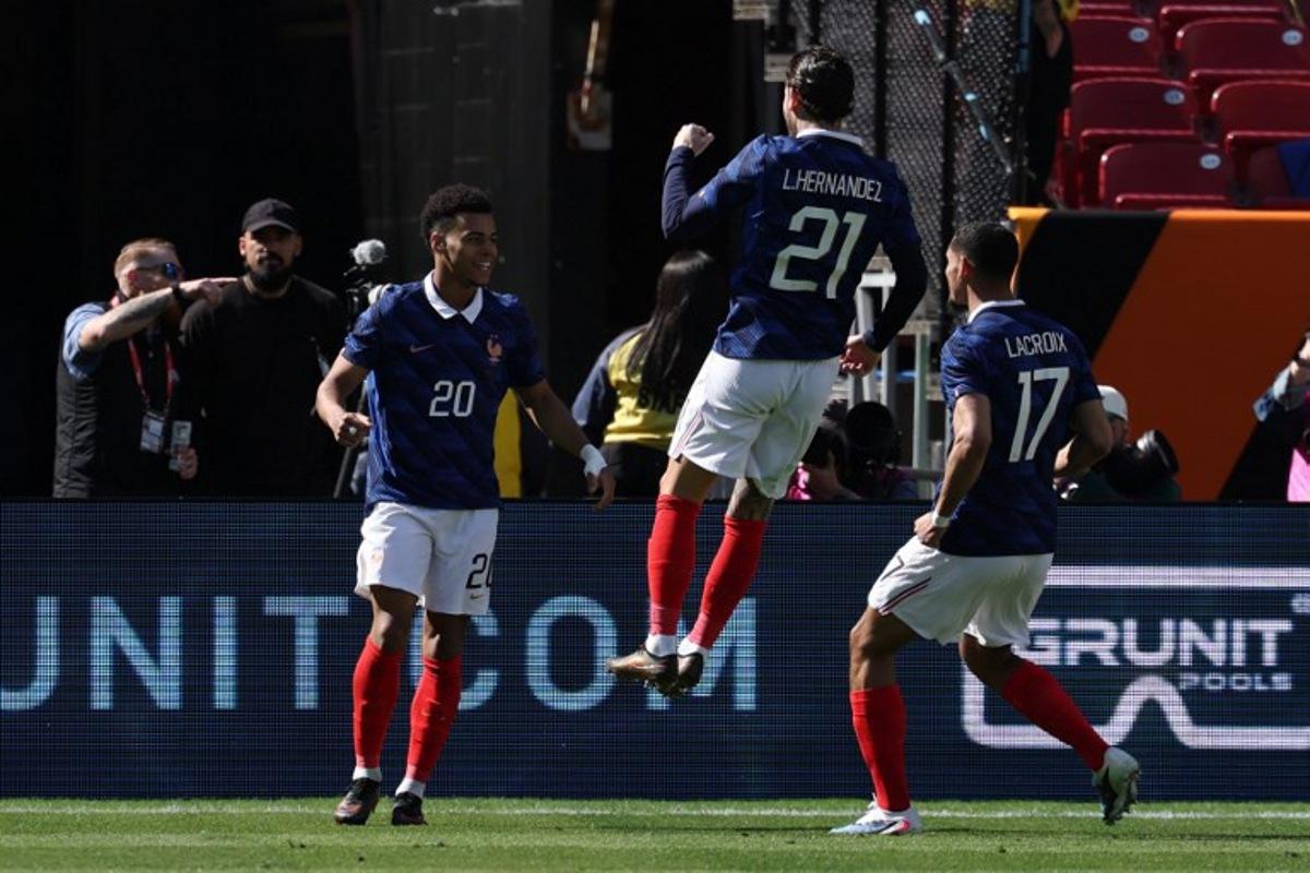 France's forward #20 Desire Doue celebrates with France's defender #21 Lucas Hernandez and France's defender #17 Maxence Lacroix after scoring during a friendly football match between Colombia and France at Northwest Stadium in Landover, Maryland, on March 29, 2026. FRANCK FIFE / AFP