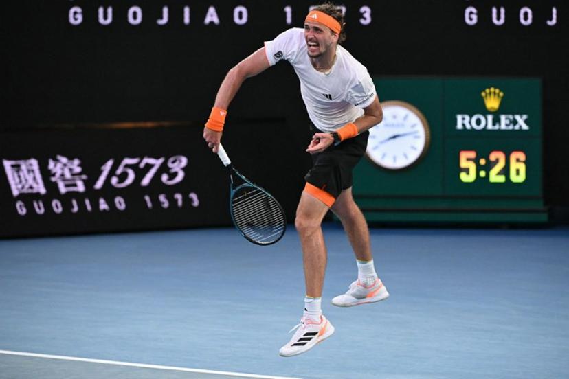 Germany's Alexander Zverev serves to Spain's Carlos Alcaraz at the end of their men's singles semi-final match on day thirteen of the Australian Open tennis tournament in Melbourne on January 30, 2026. WILLIAM WEST / AFP
