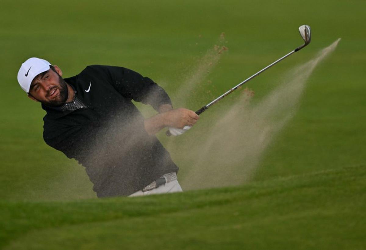 US golfer Scottie Scheffler plays from a bunker on the 12th hole on day three of the 153rd Open Championship at Royal Portrush golf club in Northern Ireland on July 19, 2025. Glyn KIRK / AFP