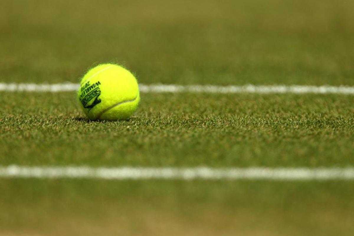 A tennisball is pictured courside during play between Czech player Tomas Berdych and Spanish player Rafael Nadal during the men's singles grand final of the Wimbledon Tennis Championships at the All England Tennis Club, in southwest London on July 4, 2010. AFP PHOTO / GLYN KIRK GLYN KIRK / AFP