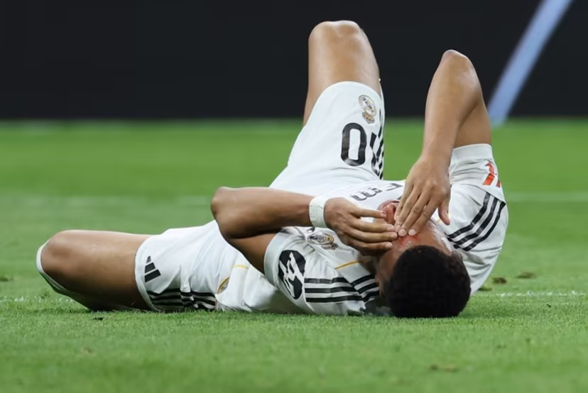Real Madrid's French forward #10 Kylian Mbappe lies on the pitch with blood on his face after colliding with Girona's Brazilian defender #12 Vitor Reis (not pictured) during the Spanish league football match between Real Madrid CF and Girona FC at the Santiago Bernabeu stadium in Madrid on April 10, 2026. Thomas COEX / AFP