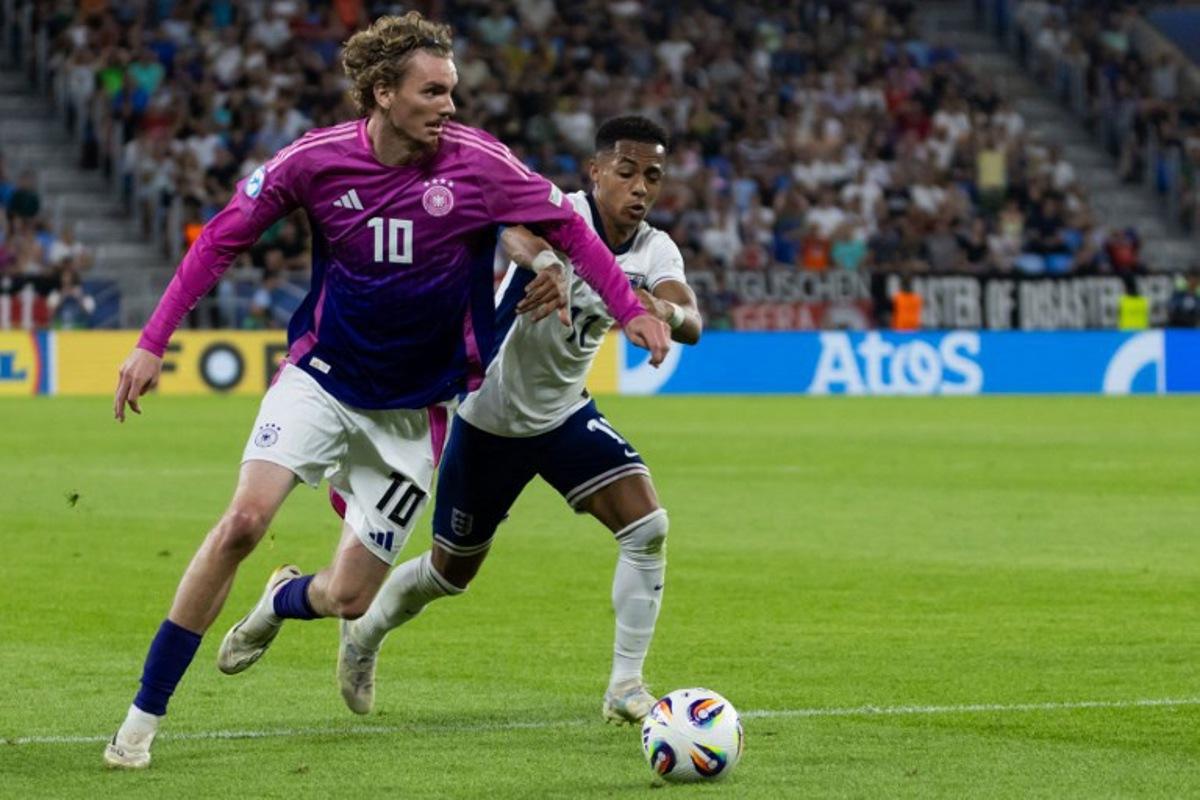 Germany's forward #10 Nick Woltemade (L) and England's forward #11 Omari Hutchinson vie for the ball during the UEFA U21 European Championship final football match between England and Germany in Bratislava, Slovakia on June 28, 2025. TOMAS BENEDIKOVIC / AFP