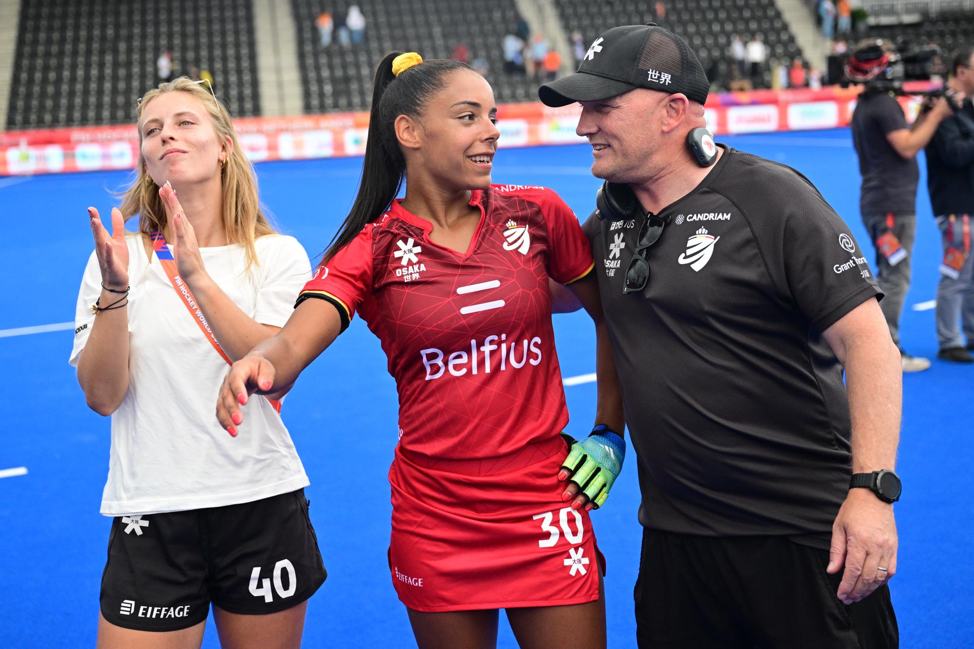 Belgium's Justine Rasir; Belgium's Ambre Ballenghien and Belgium's head coach Adam Commens celebrate after winning a field hockey game between Belgian national team Red Panthers and Australië, at the women's 2026 Hockey World Cup, on Saturday 29 August 2026 in Amsterdam. The 2026 edition of the Hockey World Cup takes place in Belgium and The Netherlands from August 15 to August 30. BELGA PHOTO DIRK WAEM