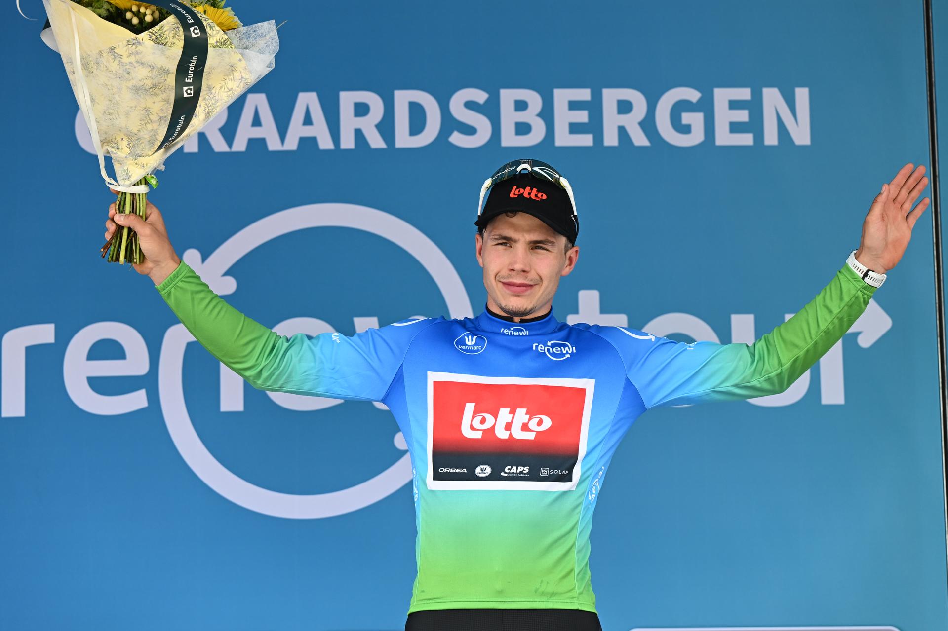 Belgian Arnaud De Lie of Lotto Cycling Team celebrates on the podium in the leaders jersey, after the third stage of the 'Renewi Tour' multi-stage cycling race, from Aalter to Geraardsbergen (179,9 km) on Friday 22 August 2025. The five-day race takes place in Belgium and the Netherlands. BELGA PHOTO DAVID PINTENS