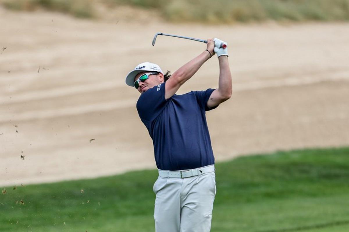 Scotland's Ewen Ferguson plays a shot on day four of the Dubai Desert Classic 2025 golf tournament at the Emirates Golf Club in Dubai on January 19, 2025. FADEL SENNA / AFP
