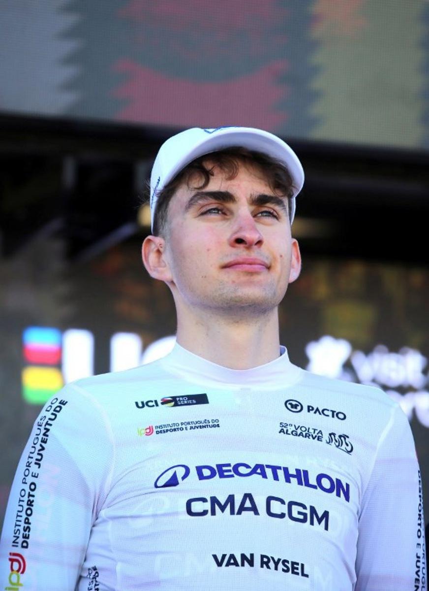 Decathlon CMA CGM Team French cyclist Paul Seixas stands on the podium wearing the best young rider's white jersey after the stage four of the Algarve Tour, a 182.10 km race from Albufeira to Lagos, on February 21, 2026. João Matos / AFP