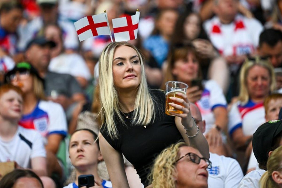 An English fan waits for the start of the UEFA Women's Euro 2025 Group D football match between England and Wales at the Arena St.Gallen in St. Gallen on July 13, 2025. Fabrice COFFRINI / AFP