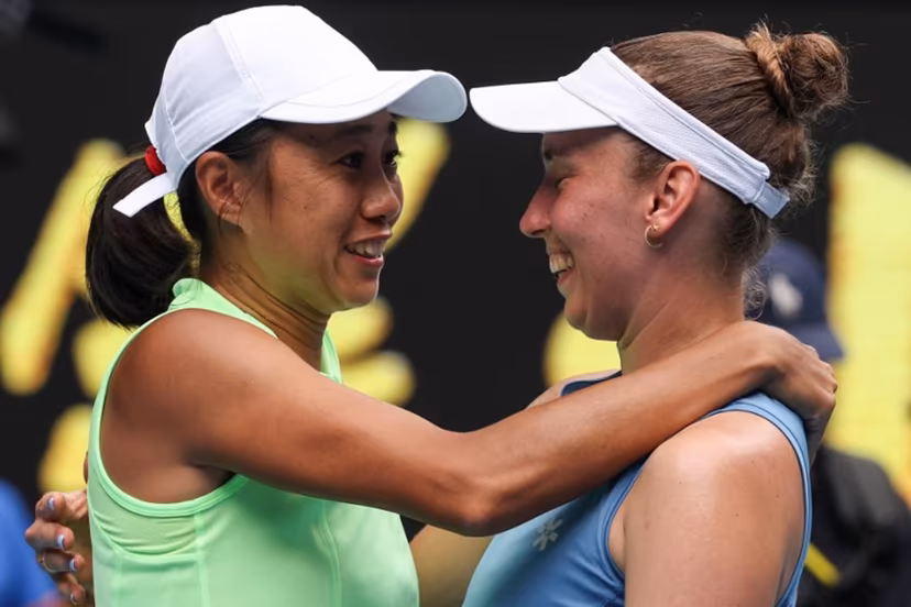 China's Zhang Shuai (L) celebrates with partner Belgium's Elise Mertens after their victory in their women's doubles final match against Kazakhstan's Anna Danilina and Serbia's Aleksandra Krunic on day fourteen of the Australian Open tennis tournament in Melbourne on January 31, 2026. DAVID GRAY / AFP