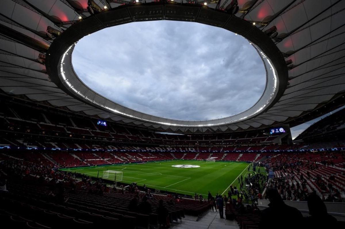 Supporters arrive before the start of the UEFA Champions League quarter final second leg football match between Club Atletico de Madrid and Manchester City FC at the Wanda Metropolitano stadium in Madrid on April 13, 2022. OSCAR DEL POZO / AFP