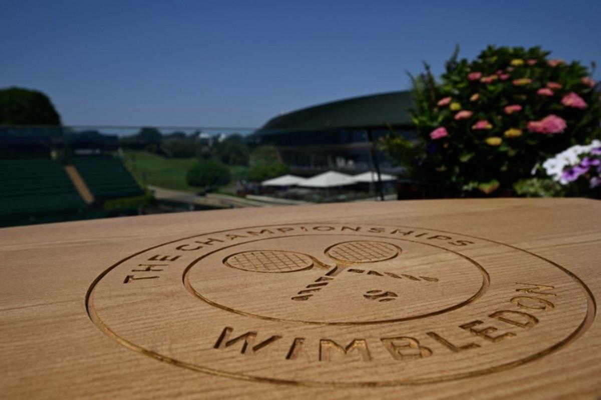 A table top engraved with the Wimbledon logo is pictured at The All England Lawn Tennis and Croquet Club in Wimbledon, southwest London, on June 24, 2026, ahead of the 2026 Wimbledon Championships. Glyn KIRK / AFP