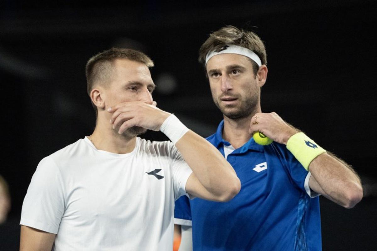 Poland's Jan Zielinski (L) and Belgium's Sander Gille speak during their men's doubles final tennis match against France's Benjamin Bonzi and France's Pierre-Hughes Herbert at the Marseille Open 13 ATP World Tour in Marseille, southern France on February 16, 2025. MIGUEL MEDINA / AFP