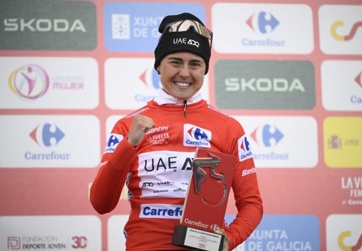 Winner of 2026 La Vuelta Femenina cycling tour of Spain, team UAE ADQ's Spanish rider Paula Blasi Cairol celebrates on the podium after the 7th stage, a 132.9 km race between Pola de Laviana and Alto de l'Angliru, on May 9, 2026. Miguel RIOPA / AFP