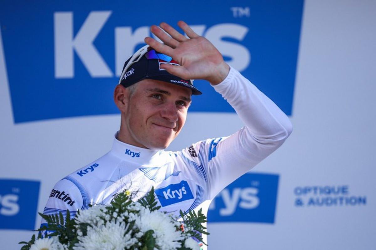 Soudal Quick-Step team's Belgian rider Remco Evenepoel celebrates on the podium with the best young rider's white jersey after the 13th stage of the 112th edition of the Tour de France cycling race, 10.9 km individual time trial between Loudenvielle and Peyragudes, in the Pyrenees mountains of southwestern France, on July 18, 2025. Anne-Christine POUJOULAT / AFP