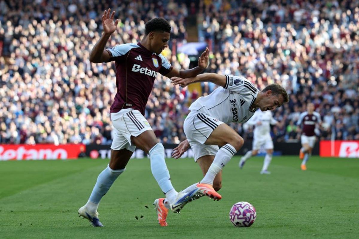 Aston Villa's English striker #11 Ollie Watkins (L) vies with Fulham's Belgian defender #21 Timothy Castagne during the English Premier League football match between Aston Villa and Fulham at Villa Park in Birmingham, central England on September 28, 2025. Darren Staples / AFP