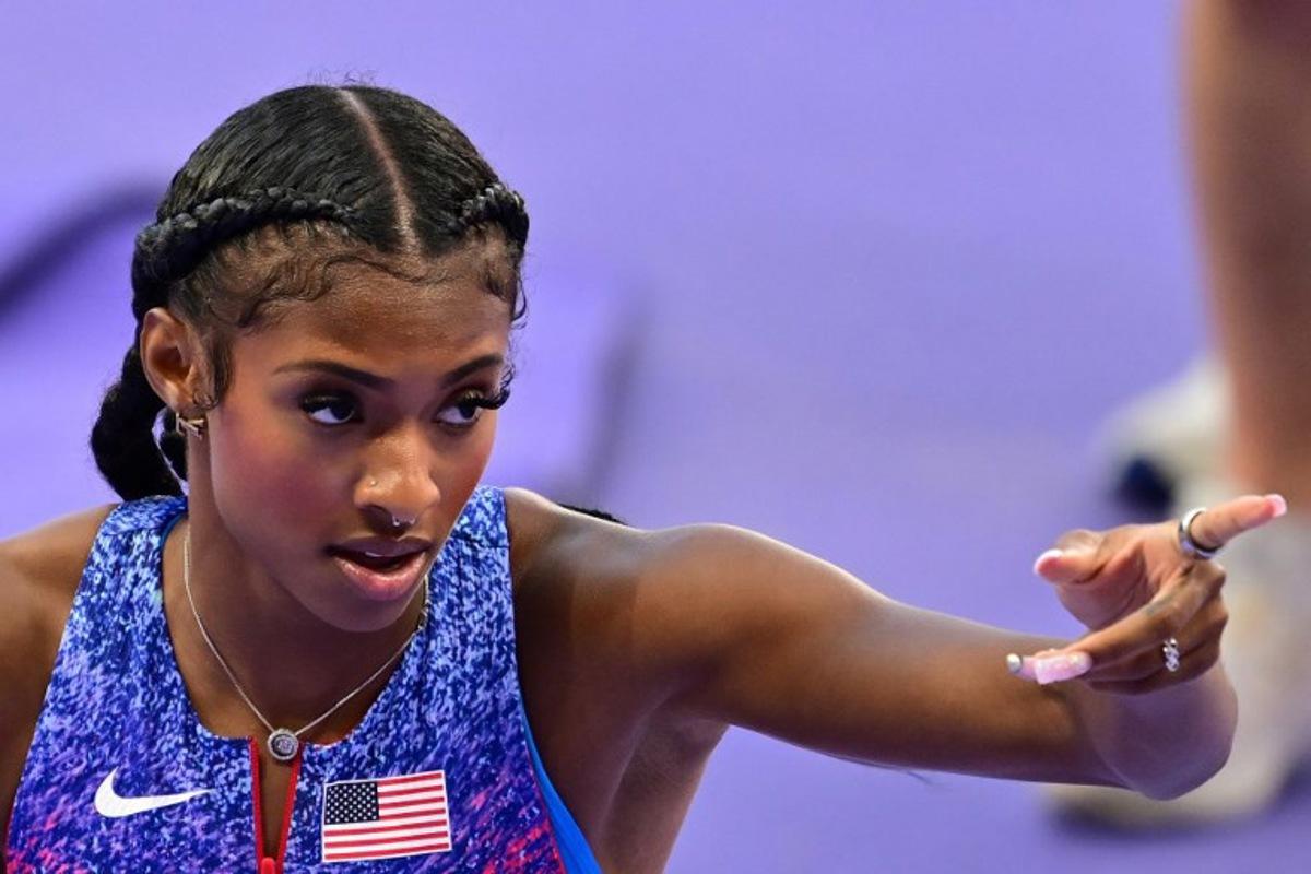 US' Masai Russell reacts after winning the women's 100m hurdles final of the athletics event at the Paris 2024 Olympic Games at Stade de France in Saint-Denis, north of Paris, on August 10, 2024. Martin BERNETTI / AFP