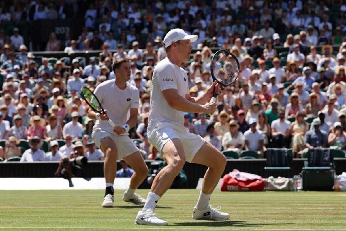 Britain's Henry Patten and Finland's Harri Heliovaara wait for a return from El Salvador's Marcelo Arevalo and Croatia's Mate Pavic during their men's doubles final tennis match on the thirteenth day of the 2026 Wimbledon Championships at The All England Lawn Tennis and Croquet Club in Wimbledon, southwest London, on July 11, 2026. Adrian Dennis / AFP