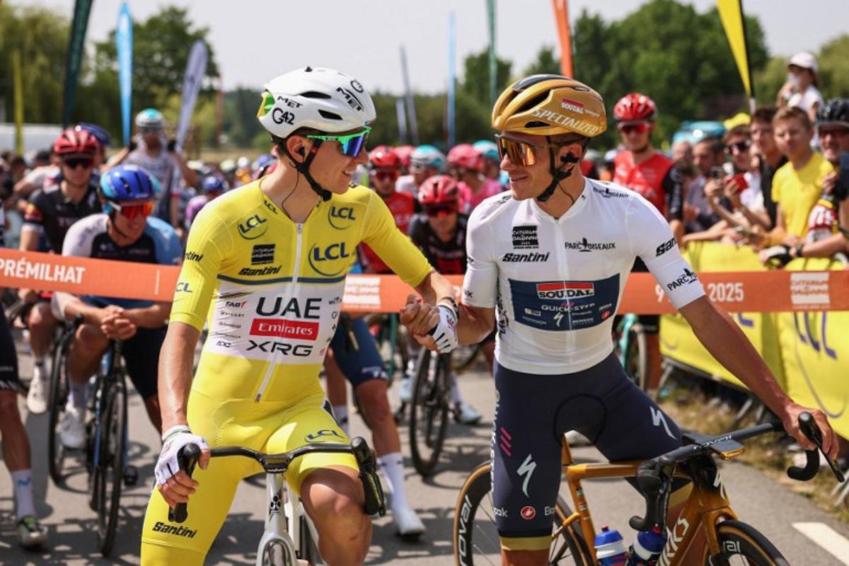 UAE Team Emirates XRG's Slovenian rider Tadej Pogačar (L) wearing the overall leader's yellow jersey shakes hands with Soudal Quick-Step's Belgian rider Remco Evenepoel wearing the best young rider's white jersey prior to the start of the 2nd stage of the 77th edition of the Criterium du Dauphine cycling race, 204,6 km between Prémilhat and Issoire, on June 9, 2025. Anne-Christine POUJOULAT / AFP