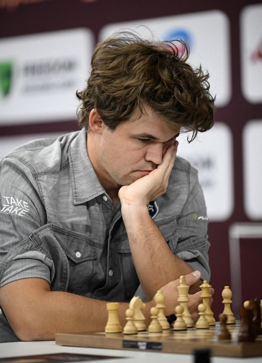 Magnus Carlsen of Norway plays against Rudik Makarian of Russia in the 15th round of the Blitz Open during the FIDE World Rapid and Blitz Championships 2025 at Qatar University's Sports and Events Complex in Doha on December 30, 2025. Mahmud HAMS / AFP