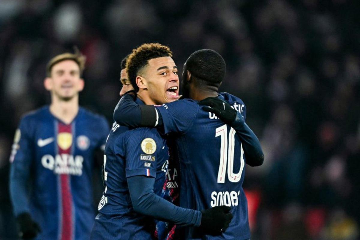 Paris Saint-Germain's French forward #10 Ousmane Dembele (R) celebrates with Paris Saint-Germain's French midfielder #14 Desire Doue after scoring his team's second goal during the French L1 football match between Paris Saint-Germain (PSG) and Paris FC at the Parc des Princes stadium in Paris on January 4, 2026. Blanca CRUZ / AFP