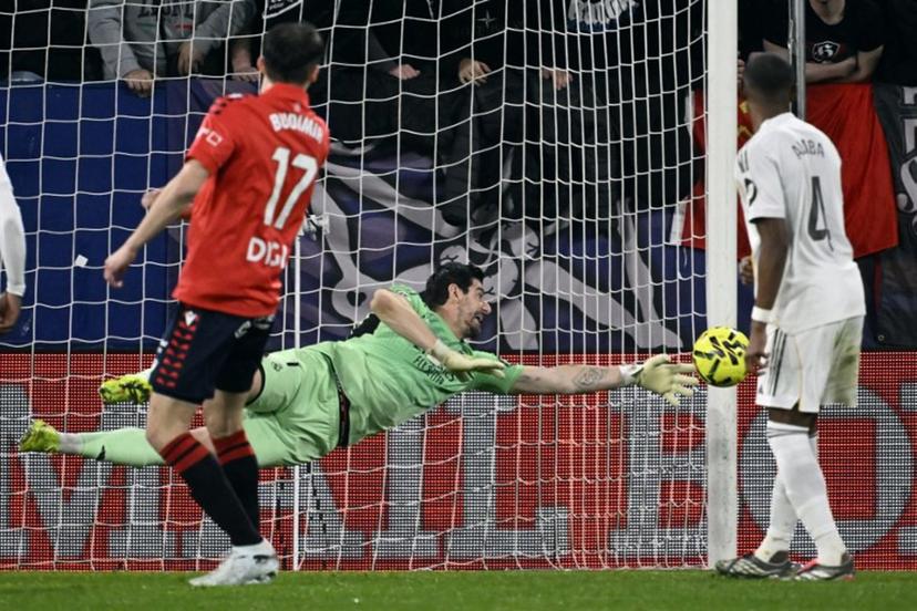 Real Madrid's Belgian goalkeeper #01 Thibaut Courtois clears the ball during the Spanish league football match between CA Osasuna and Real Madrid CF at El Sadar Stadium in Pamplona on February 21, 2026. ANDER GILLENEA / AFP