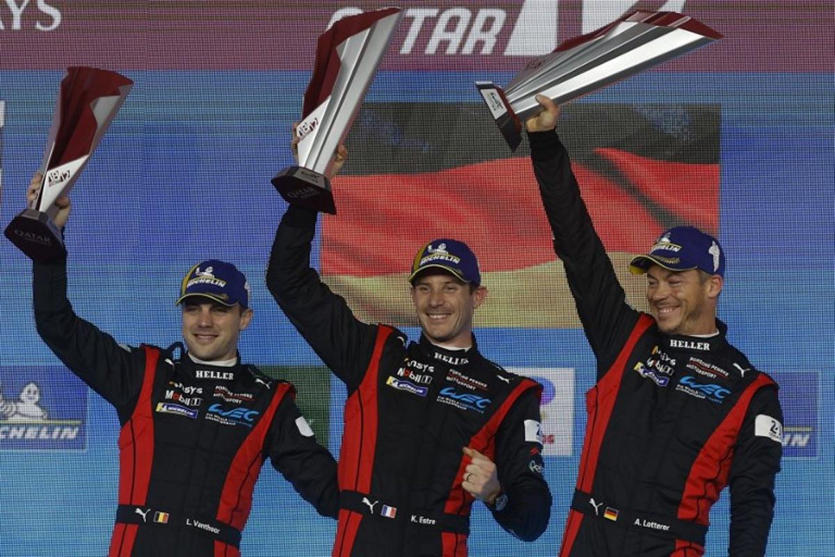 (L-R) First placed Porsche Penske Motorsport Belgium's Laurens Vanthoor, France's Kevin Estre and Germany's Andre Lotterer celebrate with their trophies after winning the Hypercar race at the season-opener of FIA World Endurance Championship 2024 at the Lusail International Circuit in Lusail, north of Doha on March 2, 2024. KARIM JAAFAR / AFP