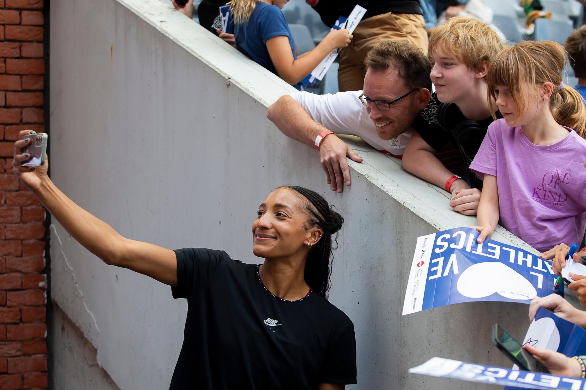 Belgian Nafissatou Nafi Thiam takes a selfie picture with some fans, during the Belgian athletics championships, Sunday 03 August 2025 in Brussels. The Belgian championships take place from 2-3 August, 2025. BELGA PHOTO KRISTOF VAN ACCOM