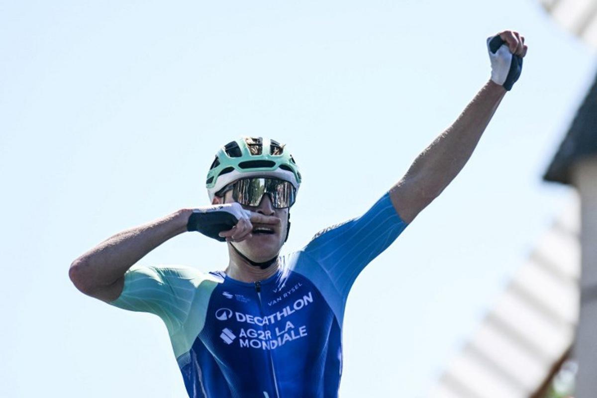 Decathlon-AG2R La Mondiale's French rider Dorian Godon gestures as he crosses the finish line to win the men's Elite race of the French National Road Cycling championships, in Les Herbiers, western France, on June 29, 2025. Sebastien Salom-Gomis / AFP