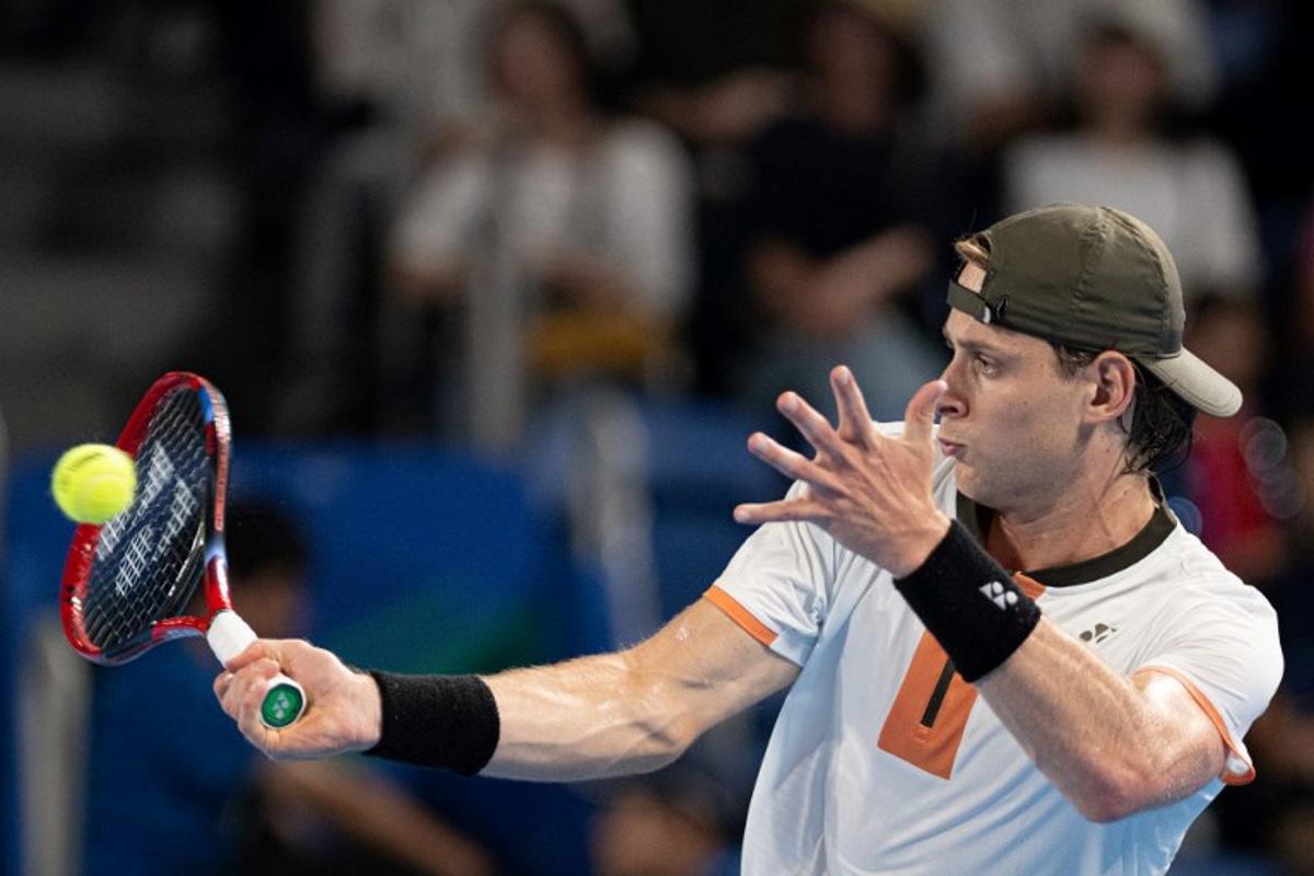 Belgium's Zizou Bergs hits a return against Spain's Carlos Alcaraz during their men's singles match at the ATP Japan Open tennis tournament in Tokyo on September 27, 2025. Philip FONG / AFP