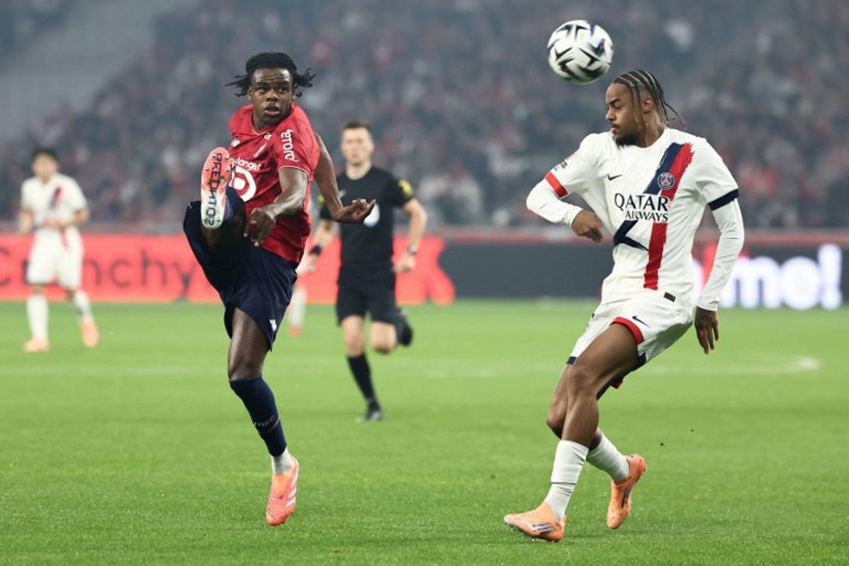 Lille's Belgian defender #03 Nathan Ngoy (CL) and Paris Saint-Germain's French forward #29 Bradley Barcola (CR) fight for the ball during the French L1 football match between Lille LOSC and Paris Saint-Germain (PSG) at the Stade Pierre-Mauroy in Villeneuve-d'Ascq, northern France, on October 5, 2025. Sameer AL-DOUMY / AFP
