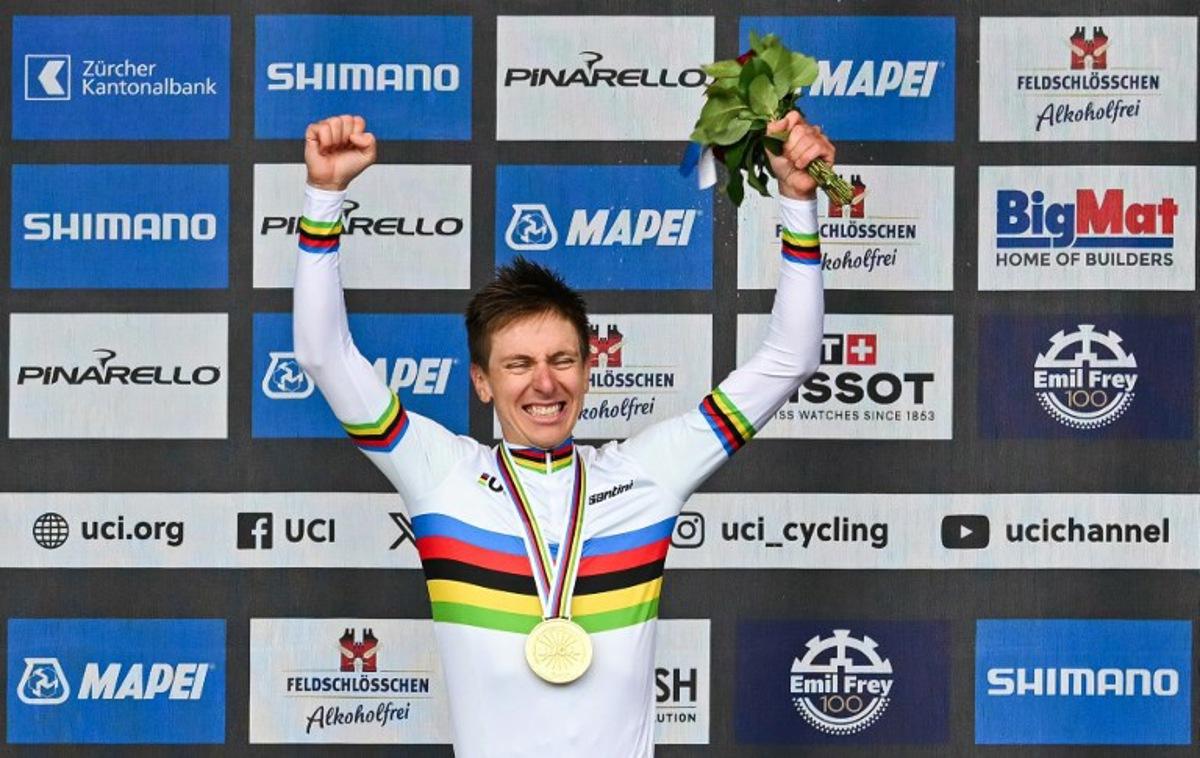 Winner Slovenia's Tadej Pogacar celebrates during the podium ceremony of the men's Elite Road Race cycling event as part of the UCI 2024 Road World Championships, in Zurich, on September 29, 2024. Fabrice COFFRINI / AFP