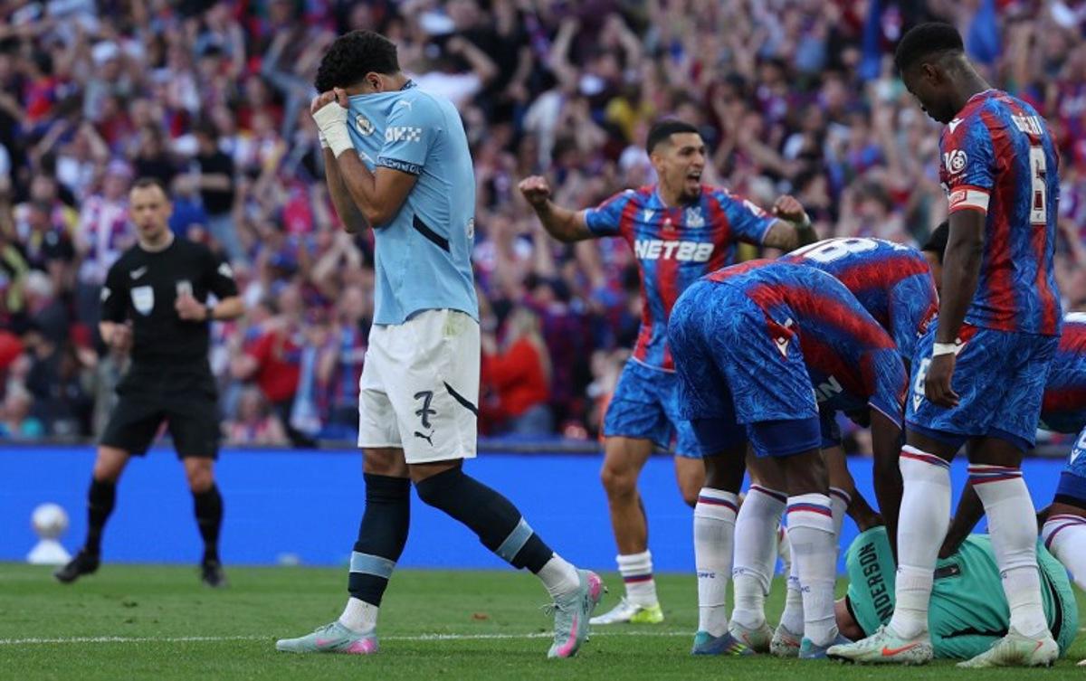 Manchester City's Egyptian striker #07 Omar Marmoush reacts as Crystal Palace's English goalkeeper #01 Dean Henderson is mobbed by teammates after saving a penalty during the English FA Cup final football match between Crystal Palace and Manchester City at Wembley stadium in London, on May 17, 2025. Adrian Dennis / AFP