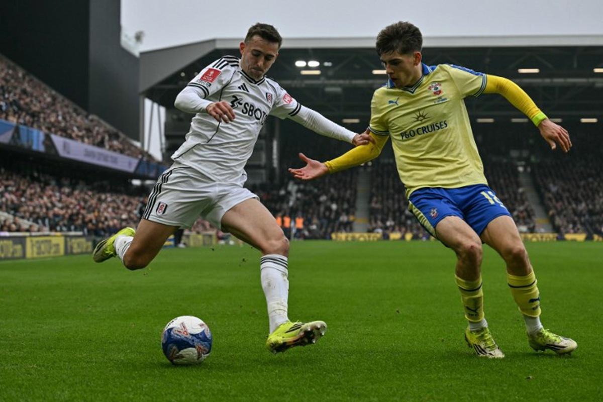 Fulham's Belgian defender #21 Timothy Castagne (L) is challenged by Southampton's English midfielder #18 Tom Fellows (R) during the English FA Cup fifth round football match between Fulham and Southampton at Craven Cottage in London on March 8, 2026. Glyn KIRK / AFP