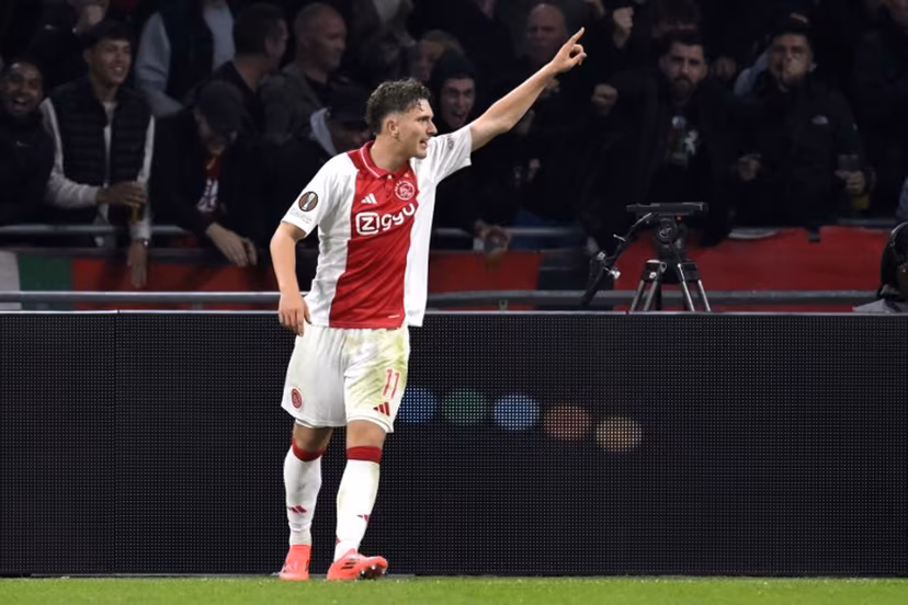 Ajax's Belgian forward #11 Mika Godts celebrates scoring his team' second goal during the UEFA Europa League football match between Ajax Amsterdam and Besiktas at The Johan Cruijff Arena Stadium in Amsterdam on September 26, 2024. JOHN THYS / AFP