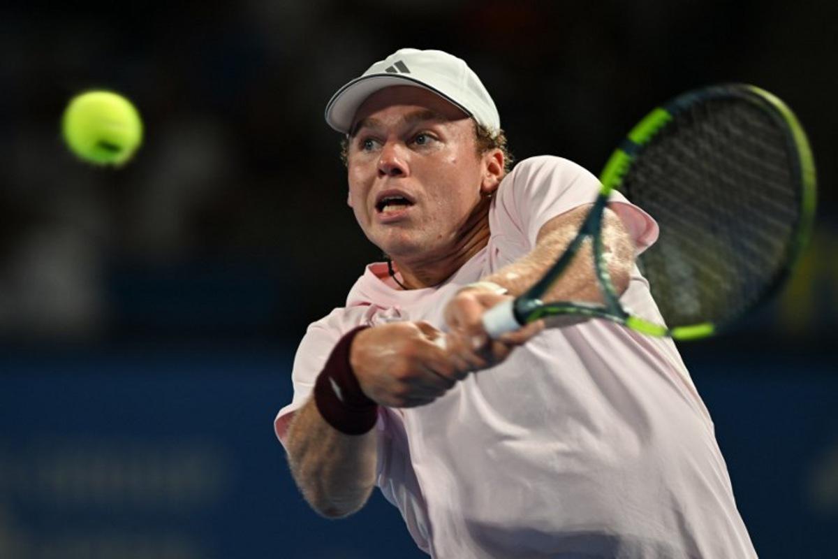USA's Alex Michelsen plays a shot to Spain's Carlos Alcaraz during their men's singles tennis match at the ATP Tour Japan Open Tennis Championships at the Ariake Tennis Forest Park in Tokyo on October 1, 2026. Rie KIKUCHI / AFP