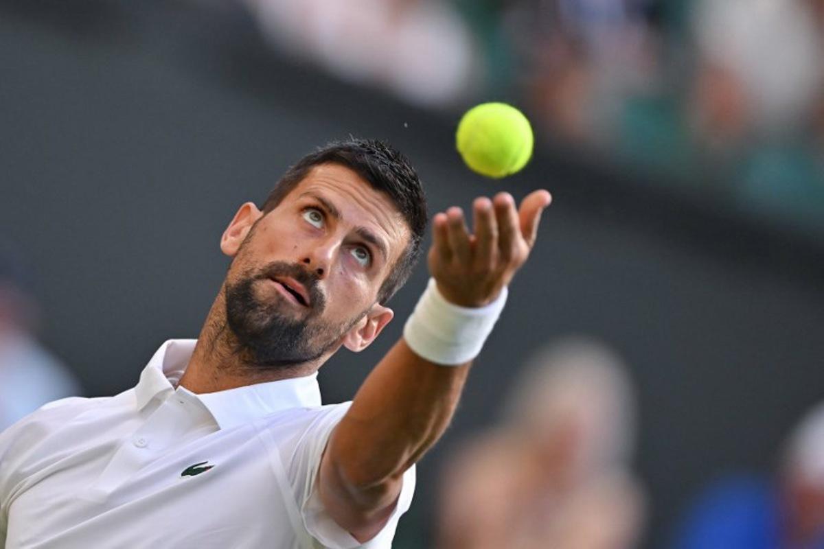 Serbia's Novak Djokovic serves to France's Alexandre Muller during their men's singles first round tennis match on the second day of the 2025 Wimbledon Championships at The All England Lawn Tennis and Croquet Club in Wimbledon, southwest London, on July 1, 2025. Glyn KIRK / AFP