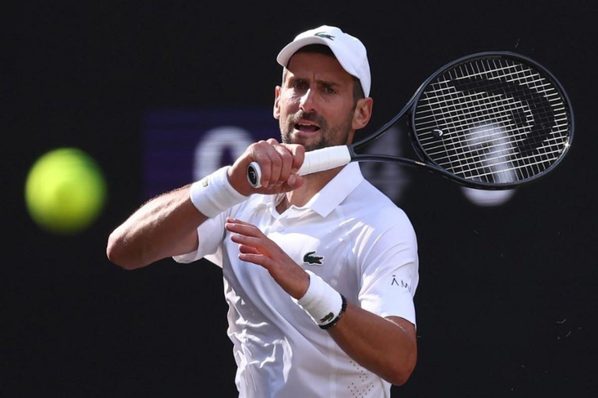 Serbia's Novak Djokovic returns to Italy's Jannik Sinner during their men's singles semi-final tennis match on the twelfth day of the 2026 Wimbledon Championships at The All England Lawn Tennis and Croquet Club in Wimbledon, southwest London, on July 10, 2026. HENRY NICHOLLS / AFP