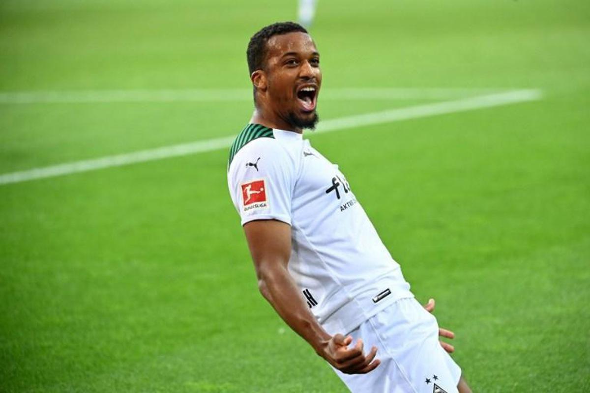 Moenchengladbach's French forward Alassane Plea celebrates scoring his team's first goal during the German first division Bundesliga football match between Borussia Moenchengladbach and FC Bayern Munich in Moenchengladbach, western Germany, on August 13, 2021. Ina Fassbender / AFP DFL REGULATIONS PROHIBIT ANY USE OF PHOTOGRAPHS AS IMAGE SEQUENCES AND/OR QUASI-VIDEO