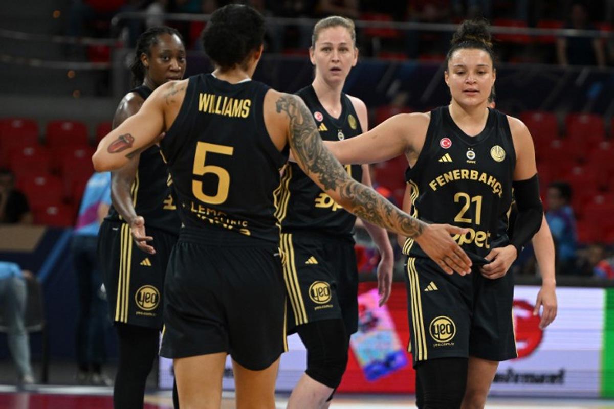 Fenerbahce players celebrate their third place after winning the Euroleague Women's final basketball match for third and fourth place between Valencia Basket Club and Fenerbahce at Pabellon Principe Felipe arena in Zaragoza on April 13, 2025. JAVIER SORIANO / AFP