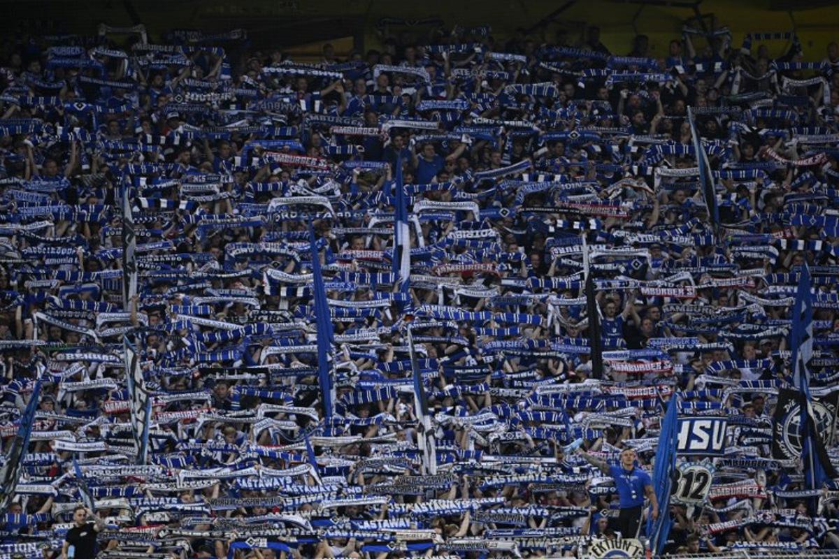 Hamburg SV fans cheer their team during the German first division Bundesliga football match between BVB Borussia Dortmund and Hamburg SV in Dortmund, western Germany on August 29, 2026. INA FASSBENDER / AFP