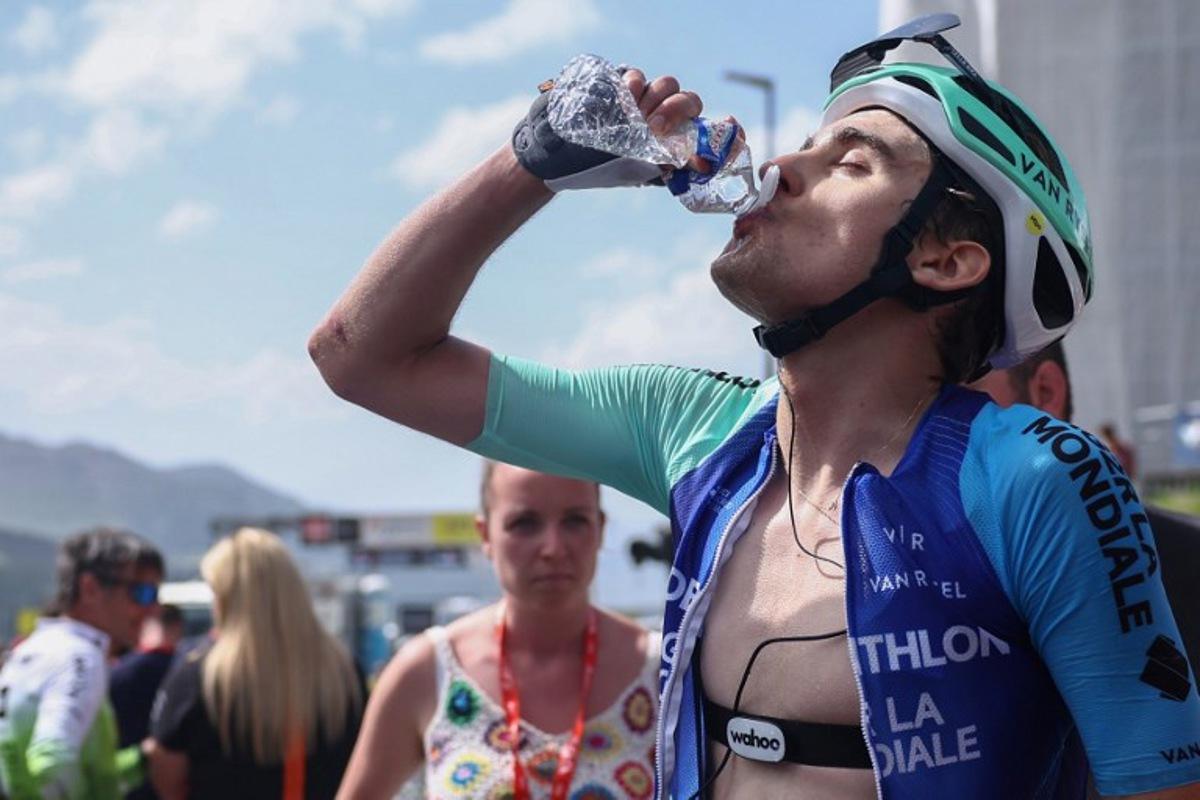 Decathlon AG2R La Mondiale Team's French rider Paul Seixas drinks from a bottle at the end of the 7th stage of the 77th edition of the Criterium du Dauphine cycling race, 131,6 km between Grand-Aigueblanche and Valmeinier, on June 14, 2025. Anne-Christine POUJOULAT / AFP