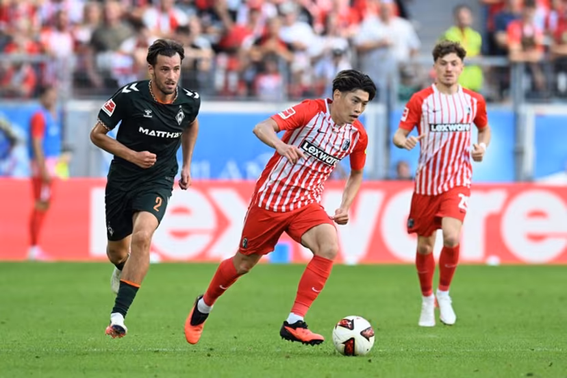 Bremen's Belgian defender #02 Olivier Deman and Freiburg's Japanese midfielder #14 Yuito Suzuki vie for the ball during the German first division Bundesliga football match between SC Freiburg and Werder Bremen in Freiburg, southern Germany, on August 30, 2026. THOMAS KIENZLE / AFP