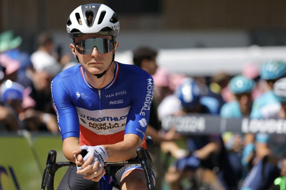 Decathlon AG2R La Mondiale Team's French rider Paul Lapeira looks on as he awaits the start of the 15th stage of the 111th edition of the Tour de France cycling race, 197,7 km between Loudenvielle and Plateau de Beille, in the Pyrenees mountains, southwestern France, on July 14, 2024. Thomas SAMSON / AFP